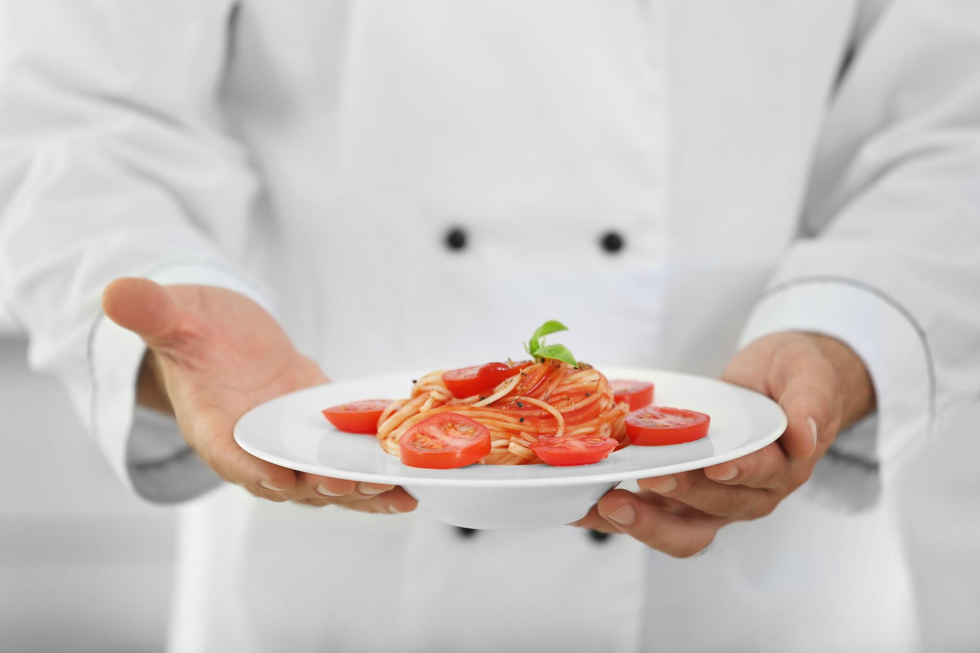 Chef preparing plated dish in studio kitchen